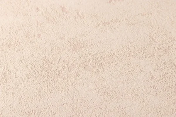 Unyqoos® Hoogwaardig vliesbehang met natuurlijke pleisterlook in zand en beige
