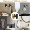 P-87213230927024-20260405181007.webp Unyqoos® Set van twee stijlvolle wandhaken in zwart-goud voor badkamer en keuken