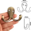 P-87213586749283-20260406115722.webp Unyqoos® Set van 6 dubbele wandhaken met antieke messing afwerking